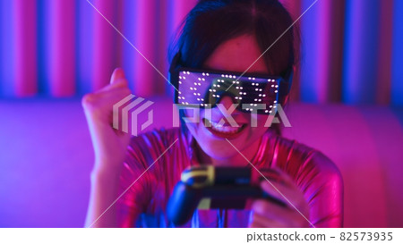 Neon asian woman dancing. Fashion model woman in neon light, portrait of beautiful model with fluorescent make-up, Art and future design of female disco dancer posing in UV, colorful make up. Neon asian woman dancing. Fashion model woman in neon light, portrait of beautiful model with fluorescent make-up, Art and future design of female disco dancer posing in UV, colorful make up. 82573935