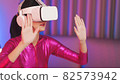 Neon  asian woman dancing. Fashion model woman in neon light, portrait of beautiful model with fluorescent make-up, Art and future design of female disco dancer posing in UV, colorful make up. 82573942