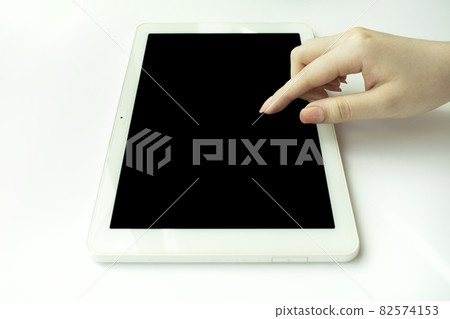 Woman's finger touching the tablet 82574153