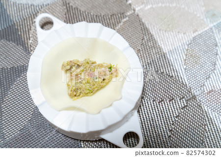 A photo of making dumplings. A photo of handmade dumplings. 82574302