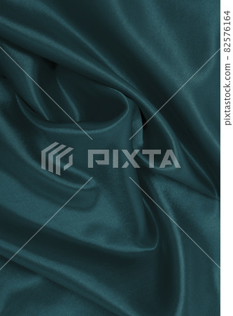 Smooth elegant blue silk or satin luxury cloth texture as abstract background. Luxurious Christmas background or New Year background design Smooth elegant blue silk or satin luxury cloth texture as abstract background. Luxurious Christmas background or New Year background design 82576164