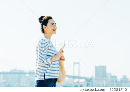 Young woman using a smartphone outdoors Young woman using a smartphone outdoors 82581740