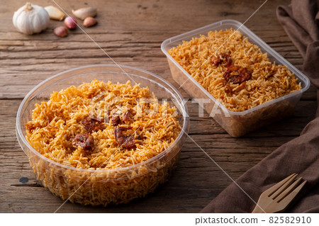 Thai dessert, Mixed Crispy Rice Noodle (Mee Krob) in Plastic food container on wood background Thai dessert, Mixed Crispy Rice Noodle (Mee Krob) in Plastic food container on wood background 82582910