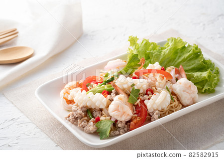 instant noodle spicy salad.Thai hot and sour noodle salad with squid shrimp and minced pork that is very flavorful and addictive instant noodle spicy salad.Thai hot and sour noodle salad with squid shrimp and minced pork that is very flavorful and addictive 82582915