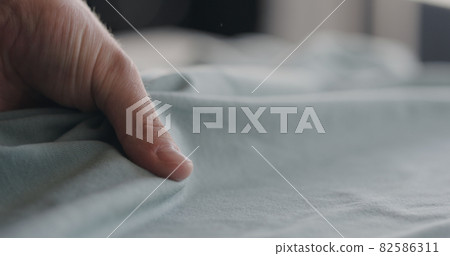 man touching cyan cotton clothes closeup 82586311