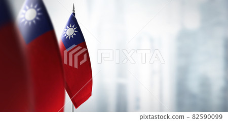 Small flags of Taiwan on a blurry background of the city Small flags of Taiwan on a blurry background of the city 82590099