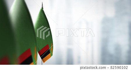 Small flags of Zambia on a blurry background of the city Small flags of Zambia on a blurry background of the city 82590102