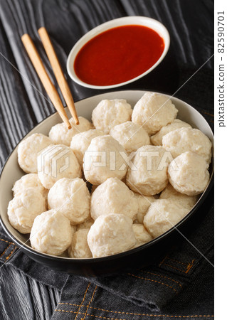 Bakso ayam Recipe Indonesian Meatballs from chicken with sauce close up in the bowl. Vertical Bakso ayam Recipe Indonesian Meatballs from chicken with sauce close up in the bowl. Vertical 82590701