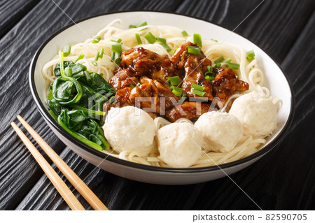 Mie ayam yellow chicken noodle and meatballs bakso closeup in the bowl. Horizontal Mie ayam yellow chicken noodle and meatballs bakso closeup in the bowl. Horizontal 82590705