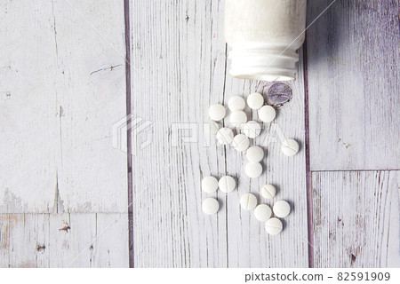 white color medical pills spilling on white background white color medical pills spilling on white background 82591909