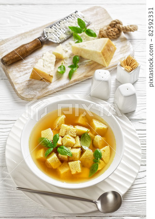soup of chicken broth with parmesan egg dumplings 82592331