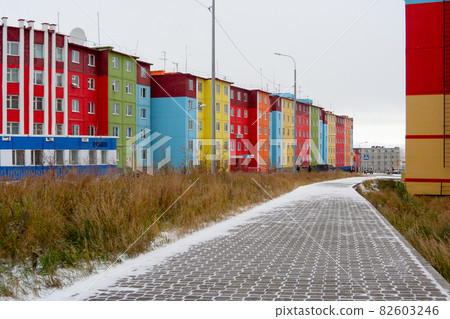Cityscape with colorful buildings and a snowy sidewalk Cityscape with colorful buildings and a snowy sidewalk 82603246