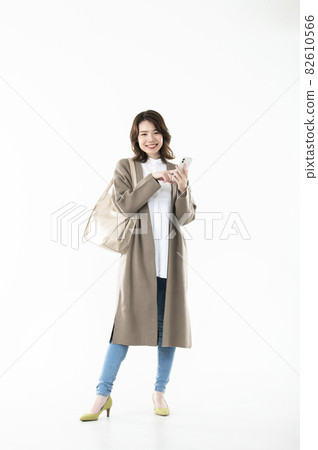 Female smartphone search, whole body, white background, smile, looking at the camera 82610566