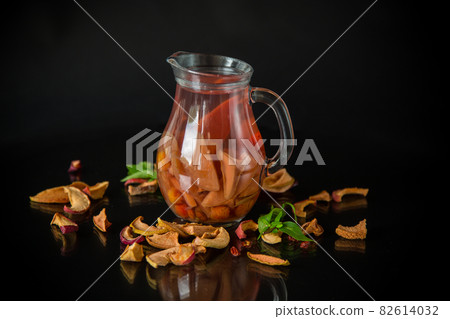 sweet cool compote boiled from various dried fruits, in a glass decanter 82614032