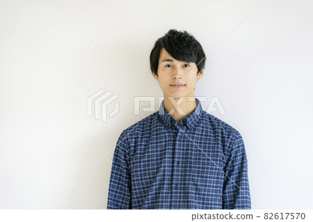 Portrait of a young man looking at the camera Portrait of a young man looking at the camera 82617570