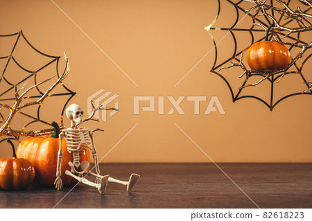 Orange halloween pumpkins with golden spider webs 82618223