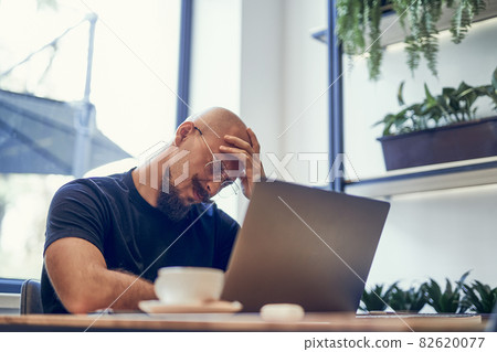 Tired young business man after long laptop pc work, having headache, feeling fatigue pain concept. Tired young business man after long laptop pc work, having headache, feeling fatigue pain concept. 82620077
