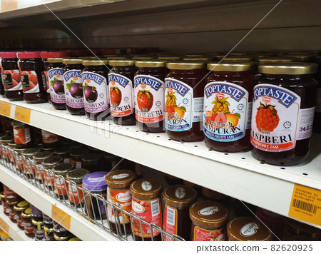 PENANG, MALAYSIA -MARCH 5, 2021: Selected focused on a variety of fruit jams displayed inside the supermarket. Sorted by the brand to facilitate customers. Tag with the price tag.  82620925