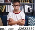 Portrait of asian boy wearing glasses in living room 82622289