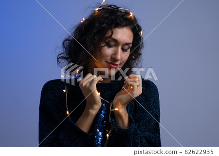 Young woman with xmas glowing lights Celebration, Christmas, New Year, Birthday Young woman with xmas glowing lights Celebration, Christmas, New Year, Birthday 82622935