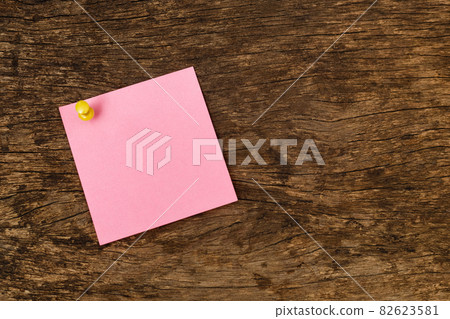 Empty sticky post note paper on wooden office table black background. Used for entering text. Empty sticky post note paper on wooden office table black background. Used for entering text. 82623581