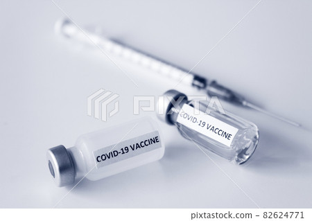 Vial of Covid-19 vaccine and 1 ml plastic syringe with needle isolated on the white background Vial of Covid-19 vaccine and 1 ml plastic syringe with needle isolated on the white background 82624771