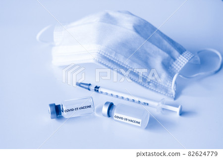 Covid-19 Prevention concept : vial of Covid-19 vaccine, 1 ml plastic syringe with needle and mask 82624779