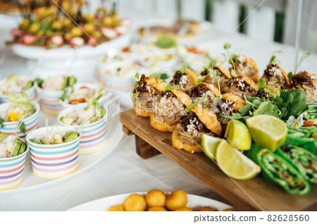 Buffet table of reception with cold snacks, meat and salads 82628560