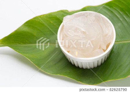 Toddy palm in cup on green leaf 82628790