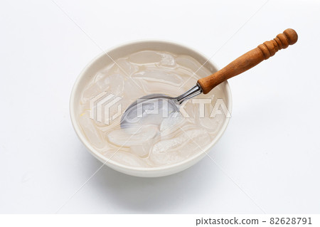 Bowl of sliced toddy palm in syrup on white background. 82628791