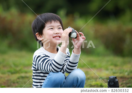 Boy eating rice balls Boy eating rice balls 82630332