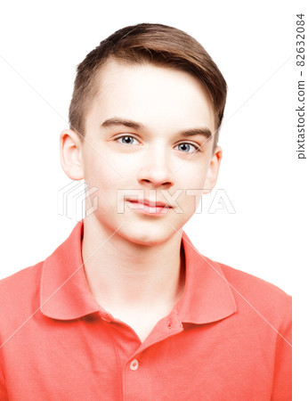 Teen boy wearing living coral trendy color polo shirt portrait isolated on white Teen boy wearing living coral trendy color polo shirt portrait isolated on white 82632084