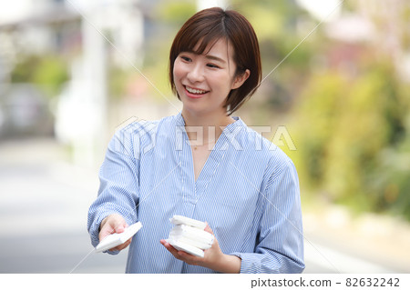 Woman giving out tissue Woman giving out tissue 82632242