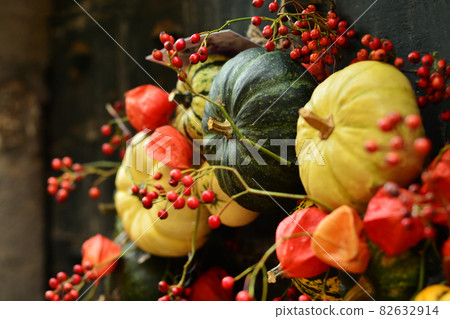 Composition of small pumpkins and zucchini on a vintage door Composition of small pumpkins and zucchini on a vintage door 82632914