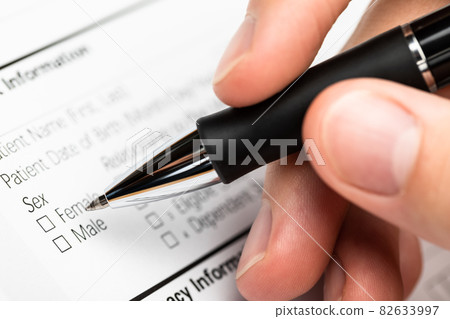 Hand with pen over gender option checkboxes in a form Hand with pen over gender option checkboxes in a form 82633997