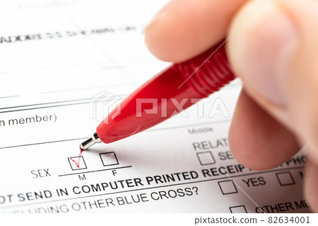 Person marking gender checkbox in a form Person marking gender checkbox in a form 82634001