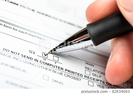 Person marking gender checkbox in a form Person marking gender checkbox in a form 82634003