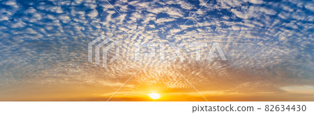 The bright sun and fluffy clouds full on blue sky, panorama nature picture. The bright sun and fluffy clouds full on blue sky, panorama nature picture. 82634430