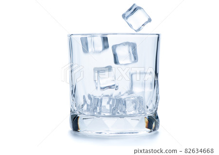 drop ice cubes in to empty Rock glass or Old Fashioned glass isolated on white drop ice cubes in to empty Rock glass or Old Fashioned glass isolated on white 82634668