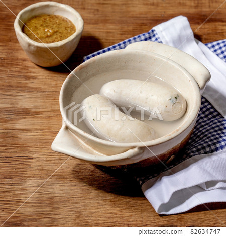 Munich Bavarian traditional white sausages in ceramic pan Munich Bavarian traditional white sausages in ceramic pan 82634747