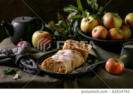 Homemade sliced traditional apple strudel pie and apples Homemade sliced traditional apple strudel pie and apples 82634763