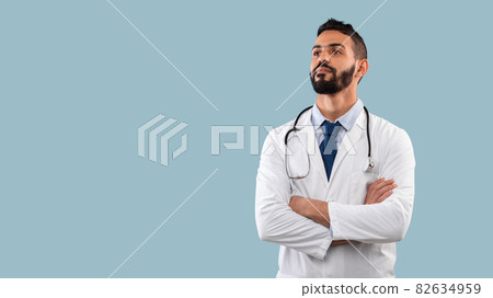 Portrait Of Confident Arabic Male Doctor Looking Aside, Blue Background Portrait Of Confident Arabic Male Doctor Looking Aside, Blue Background 82634959