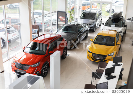 Beautiful modern cars at luxury dealership salon, view above Beautiful modern cars at luxury dealership salon, view above 82635059