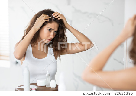 Frustrated Lady Searching Hair Flakes Suffering From Dandruff Problem Indoors Frustrated Lady Searching Hair Flakes Suffering From Dandruff Problem Indoors 82635380