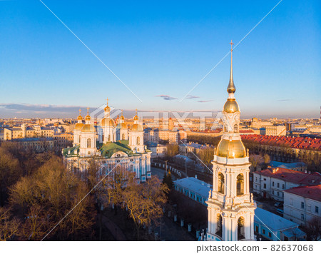 Aerial top view to St. Nicholas Naval Sea Cathedral in sunny day. Panorama of evening historical city center. Orthodox church located on banks of Kryukov and Griboyedov canal. Saint Petersburg. Russia Aerial top view to St. Nicholas Naval Sea Cathedral in sunny day. Panorama of evening historical city center. Orthodox church located on banks of Kryukov and Griboyedov canal. Saint Petersburg. Russia 82637068