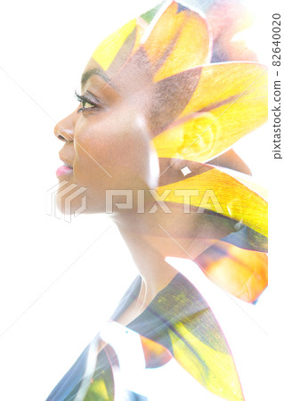 A portrait of an attractive woman combined with tropical leaves in a double exposure technique. A portrait of an attractive woman combined with tropical leaves in a double exposure technique. 82640020