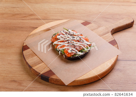 Sandwich with smoked and salted salmon, arugula and sauce 82641634