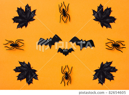 Halloween decorations on orange background, flat lay Halloween decorations on orange background, flat lay 82654605