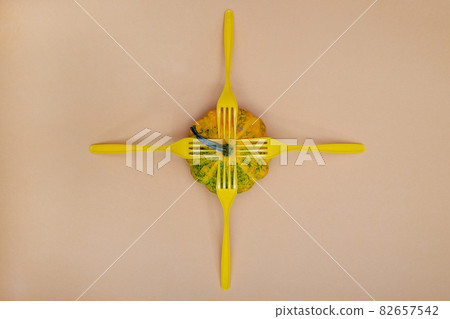 Abstract still life with ripe squash and yellow forks Abstract still life with ripe squash and yellow forks 82657542