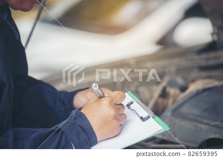 Mechanic car service auto garage in automotive mobile center. Technician workshop repair engine motor vehicles service mechanical engineering business. Automobile mechanic hands car repairs technic Mechanic car service auto garage in automotive mobile center. Technician workshop repair engine motor vehicles service mechanical engineering business. Automobile mechanic hands car repairs technic 82659395